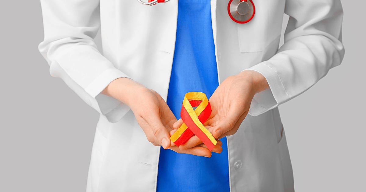 Female doctor holding hepatitis awareness ribbon with grey background